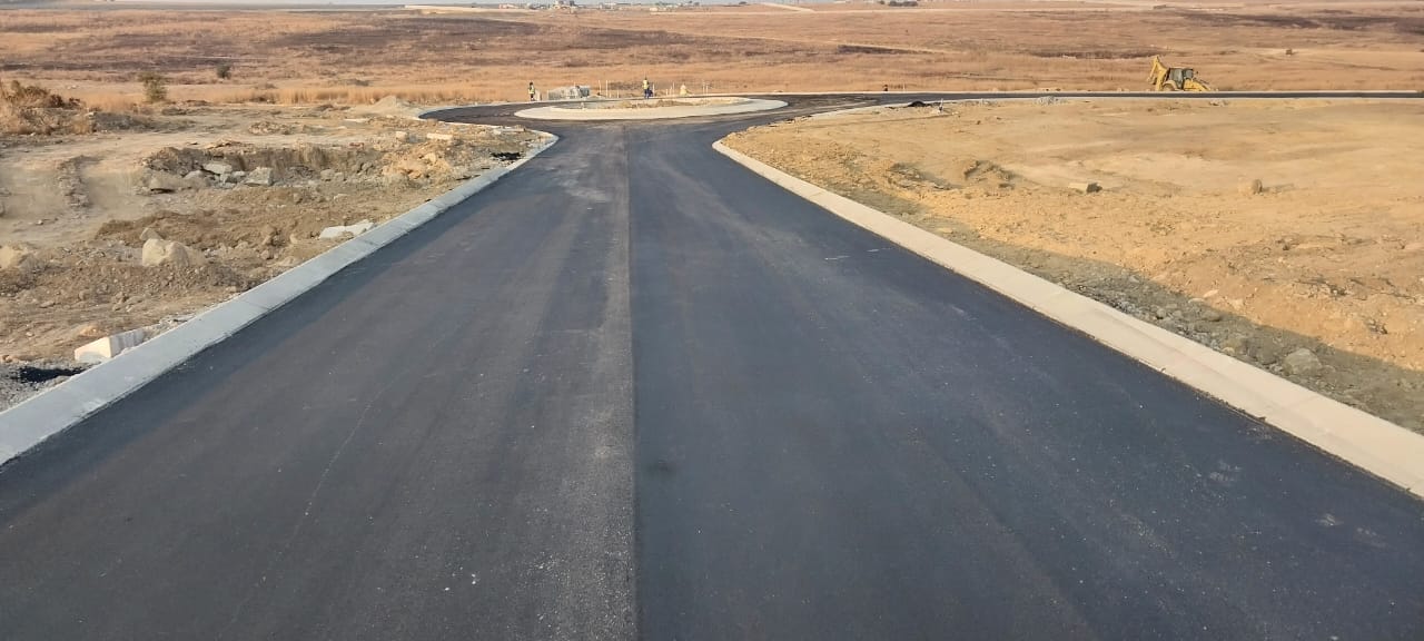 Newly surfaced black asphalt road stretching into the distance